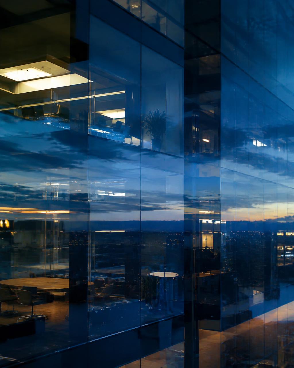Glass office tower at dusk